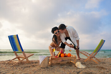 Glamour young couple resting on the beach