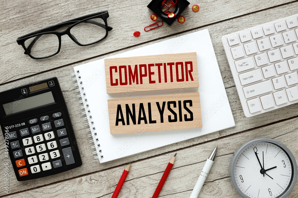 Poster competitor analysis concept. business concept. wooden blocks on a notepad on a light table. text on 
