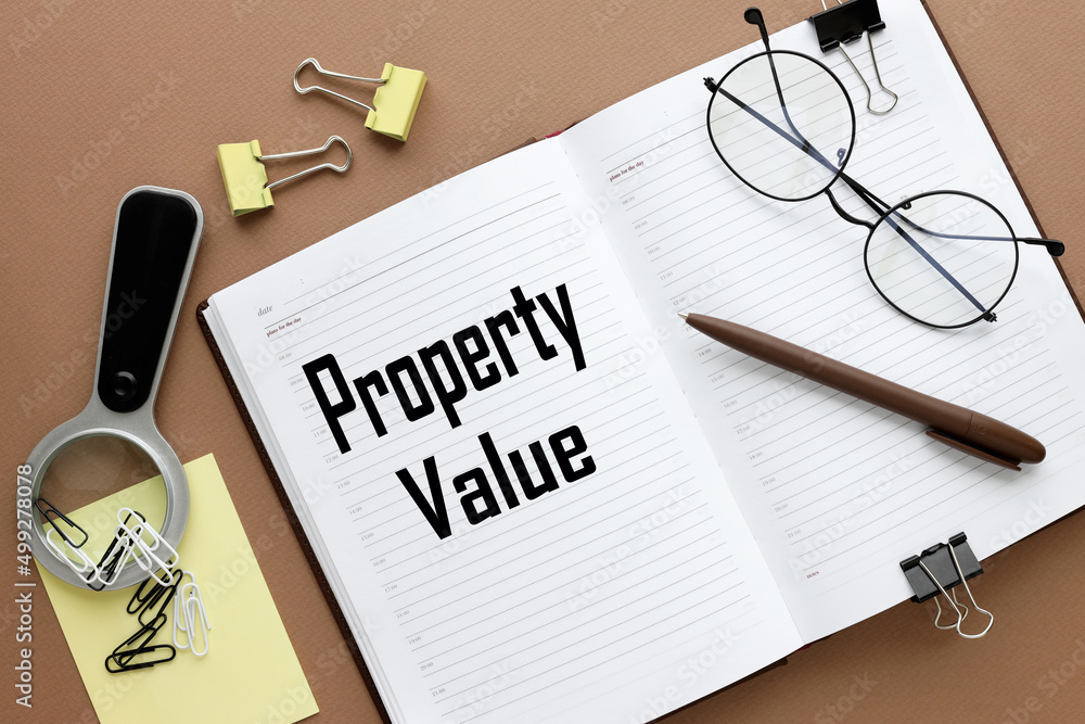 Poster property value. text on an open diary. stickers and magnifier