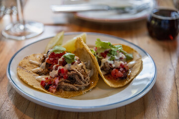 person eating mexican taco in restaurant