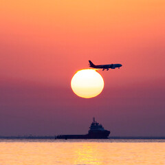 Aircraft landing over sunset in Doha