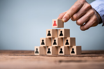 Hand Building Business Pyramid With Blocks