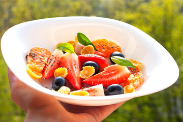 plate with fruit salad and cornflakes
