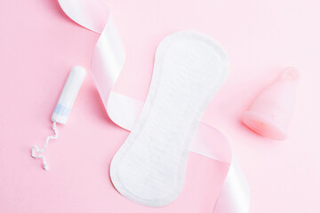 Menstrual cup, tampon, woman cup for sanitary protection. Pink ribbon with menstrual cup. Menstruation feminine period. Zero waste concept, ecofriendly lifestyle, reduced banner consumption.
