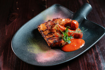 Grilled meat with tomato sauce served on a shovel.