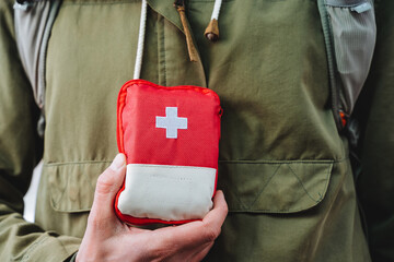 A first aid kit bag for tourists, a red first aid kit, a small tourist cosmetic bag with medicines,...