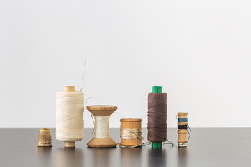 Spools of thread, needle and thimble