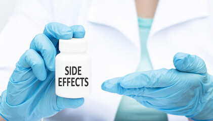 Fototapeta premium The doctor is holding a jar of text side effects in his hands. medical and healthcare concept