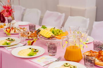 pink tablecloth, mashed potatoes with cutlet on table served for children