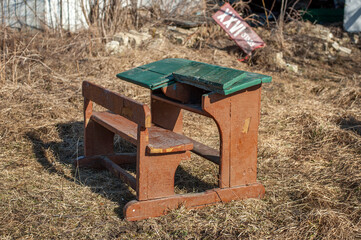 Old school desk in the courtyard of a rural house