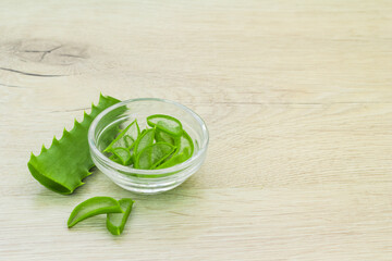 aloe vera slice top view texture background. aloe leaves, glass bowl with chopped leaves