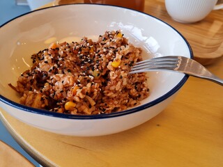 White plate with sesame rice and iron fork