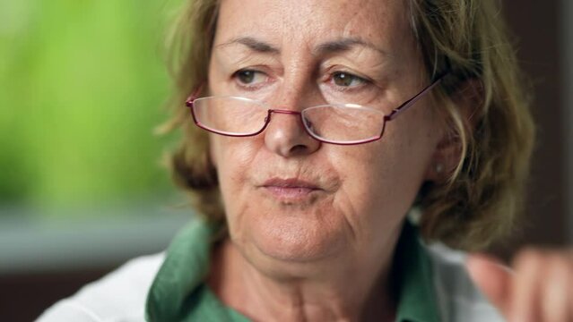 A contemplative senior woman portrait face thinking a meditative older person