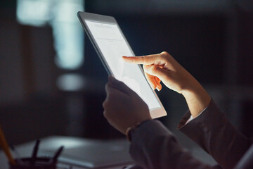 Let your finger do all the work. Cropped shot of an unrecognizable businesswoman using a tablet in the office.