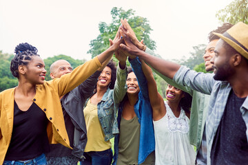 Were each others motivation. Shot of a group of friends reaching for a high five.