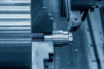 The  CNC lathe machine forming  cutting the metal shaft parts.