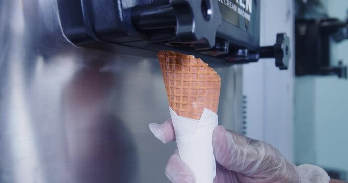 Ice cream machine for cooking and making delicious mango ice cream. closeup shot. slow motion