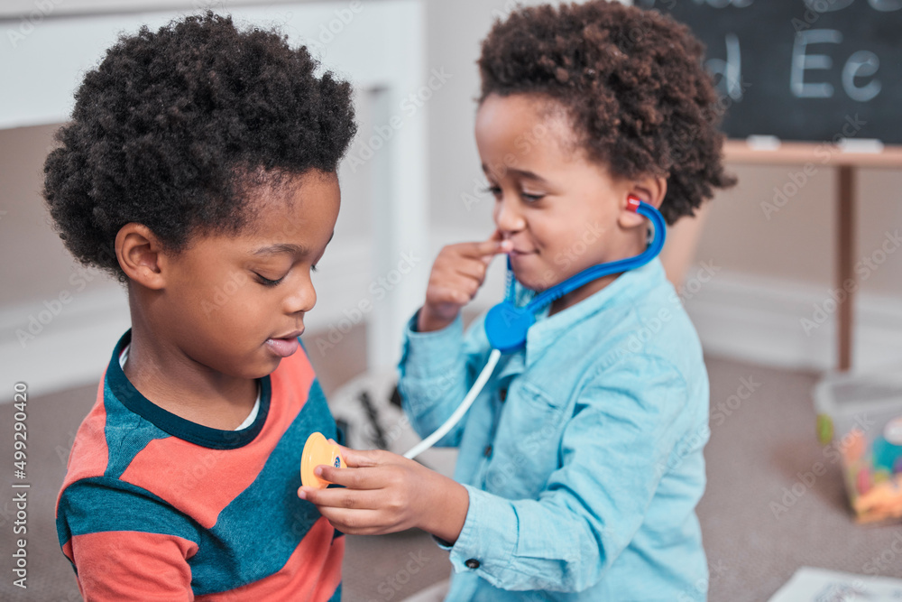 Poster Ill be the doctor and youre my patient. Shot of a boy using a toy stethoscope on his.