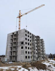Fototapeta na wymiar Crane and unfinished house. Building construction