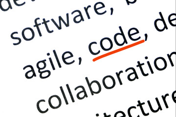 Word code undelnines among other words printed on white paper