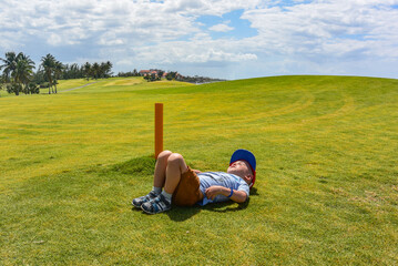 A Cuban boy gets high on a Golf course in Varadero, Cuba. One of the best Golf courses in the...