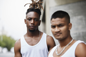 A gang is more than a family. Cropped portrait of two handsome young male gangsters standing...