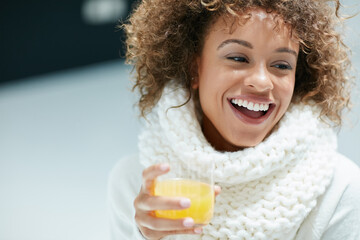 Keeping winter colds and flu at bay the citrusy way. Shot of a young woman dressed in warm clothing...