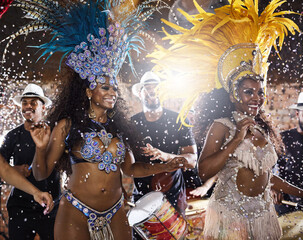 Shaking to the Brazilian beats. Shot of samba dancers performing in a carnival.