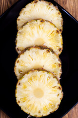 cut into pieces ripe yellow pineapple on the table