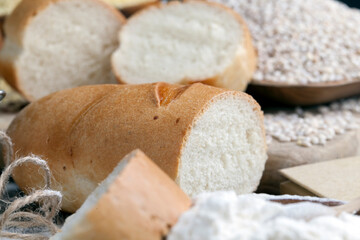 Fototapeta na wymiar wheat baguette on the table with flour and various plant grains