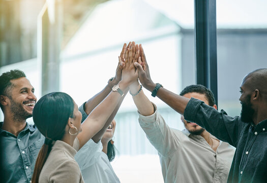 Im So Proud Of This Team. Shot Of A Group Of Coworkers High Fiving Each Other.