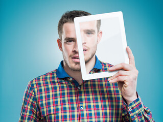Personalised technology - A part of everyday existance. A young man holding an advanced digital...