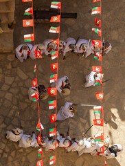 Omani men celebrate the National Day with drums and swords, a traditional art called Al Razha