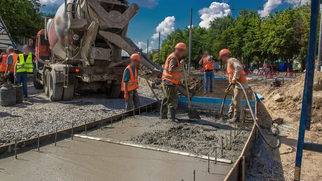 Concrete leveling works for road construction with many workers and mixer timelapse