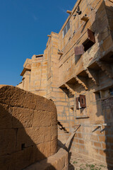 Fototapeta na wymiar Jaisalmer,Rajasthan,India - October 15, 2019 : Jaisalmer Fort or Sonar Quila or Golden Fort, made of yellow sandstone, in the morning light. UNESCO world heritage site at Thar desert.