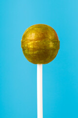 Multi-colored candies on a stick, blue background.Many colorful lollipops (Chyupa-Chyups) on a blue background