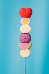 Multi-colored candies on a stick, blue background.Many colorful lollipops (Chyupa-Chyups) on a blue background