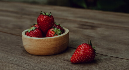 Fresh juicy strawberries on natural wooden background. Tochiotome Japanese strawberry.