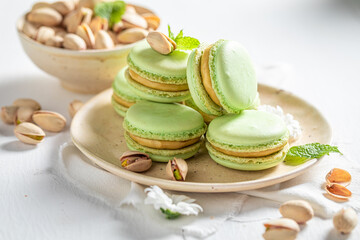 Obraz na płótnie Canvas Homemade and sweet pistachio macaroons as a tasty spring snack.