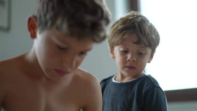 Candid two small brothers together authentic siblings