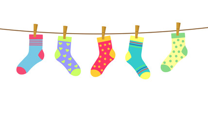colorful bright socks on a rope with clothespins against a background of sky and clouds. Cute clothes