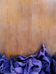 Blue,purple cloth,placed on brown wooden background