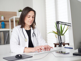 Female Doctor working at office desk