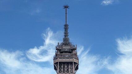 Paris, France - September 2016: Mobile telecommunications antennas and equipment at top of Eiffel tower with clear blue sky - Powered by Adobe