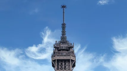 Zelfklevend Fotobehang Paris, France - September 2016: Mobile telecommunications antennas and equipment at top of Eiffel tower with clear blue sky © CanYalicn