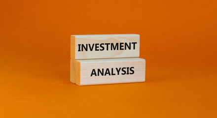 Investment analysis symbol. Wooden blocks with concept words Investment analysis on beautiful orange background. Business investment analysis concept. Copy space.