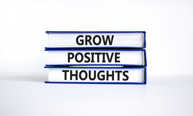 Grow positive thoughts symbol. Concept words Grow positive thoughts on books. Beautiful white table...