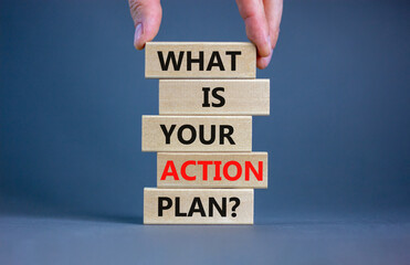 Action plan symbol. Concept words What is your action plan on wooden blocks. Businessman hand. Beautiful grey table grey background. Business What is your action plan concept. Copy space.