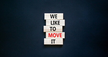 We like to move it symbol. Concept words We like to move it on wooden blocks. Beautiful black table black background. Business motivational We like to move it concept. Copy space.