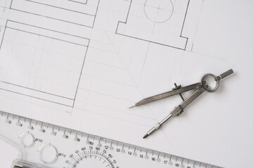 architect drawing on paper with compass and ruler